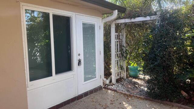 doorway to property with stucco siding