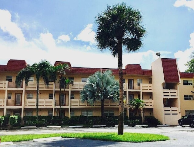 view of property featuring uncovered parking