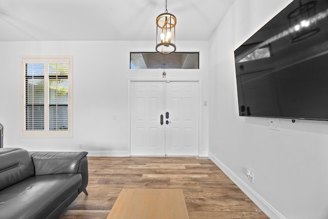 entrance foyer with baseboards and wood finished floors