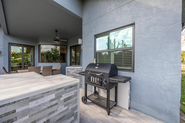 view of patio featuring a ceiling fan and area for grilling