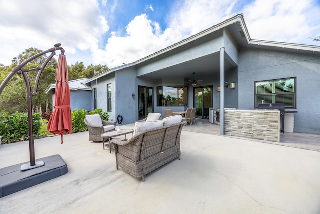 view of patio with outdoor lounge area, ceiling fan, outdoor dry bar, and grilling area