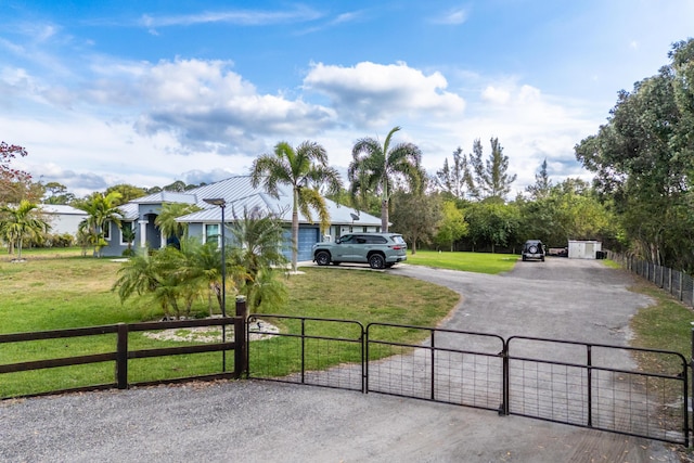 view of street featuring a gate and driveway