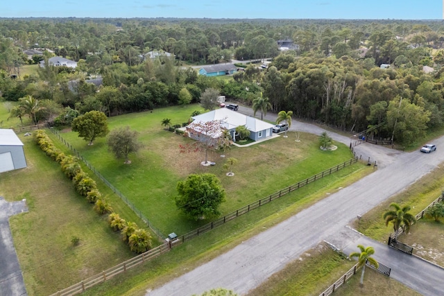 birds eye view of property with a rural view and a wooded view