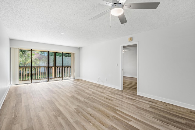 empty room featuring baseboards, light wood-style flooring, a textured ceiling, and a ceiling fan