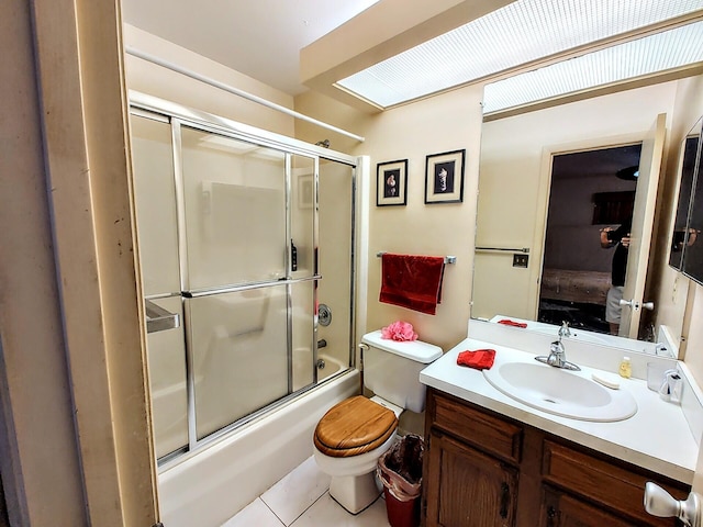 full bathroom with shower / bath combination with glass door, toilet, ensuite bathroom, vanity, and tile patterned flooring