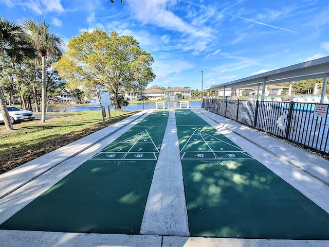 view of community featuring shuffleboard and fence