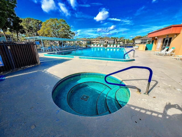 pool with fence and a patio