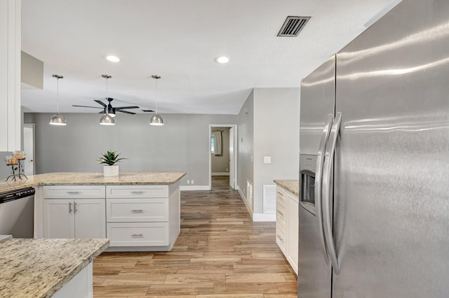 kitchen featuring white cabinets, light wood finished floors, visible vents, and stainless steel appliances