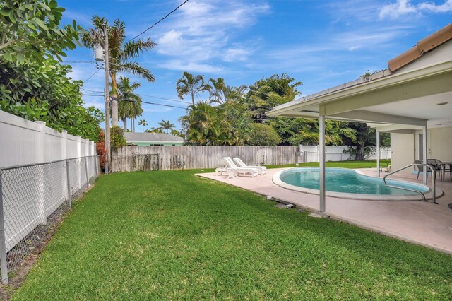 view of yard with a fenced in pool, a fenced backyard, and a patio