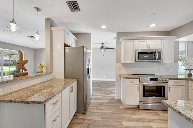 kitchen featuring stainless steel appliances, visible vents, white cabinets, backsplash, and light wood finished floors