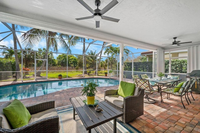 sunroom / solarium featuring ceiling fan and a pool