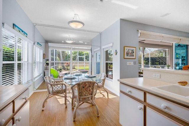 dining area with light wood finished floors and baseboards