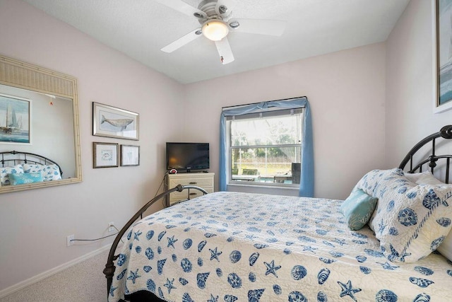 bedroom with a ceiling fan, carpet, and baseboards