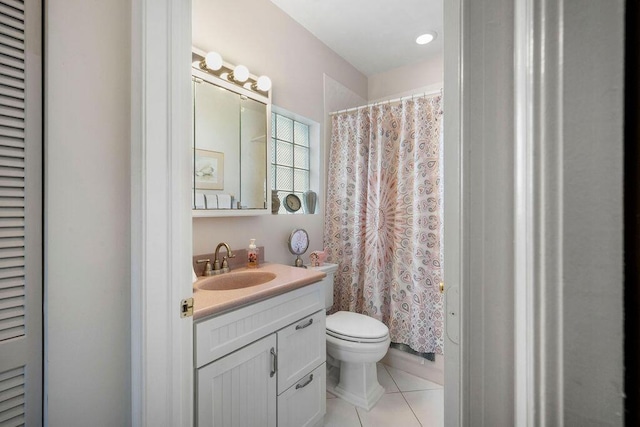 full bath with a closet, vanity, toilet, and tile patterned floors