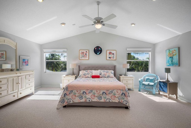 bedroom with light carpet, vaulted ceiling, baseboards, and ceiling fan