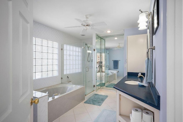 bathroom with ceiling fan, vanity, a shower stall, tile patterned flooring, and a bath