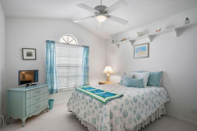 bedroom featuring ceiling fan, a textured ceiling, light carpet, baseboards, and vaulted ceiling