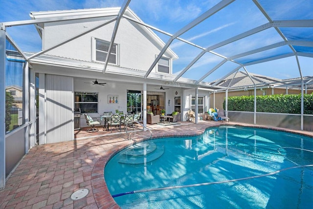 outdoor pool with a lanai, ceiling fan, an outdoor living space, and a patio