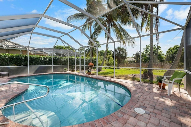 view of swimming pool with a fenced in pool, a patio area, and glass enclosure