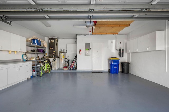 garage featuring water heater, electric panel, and a garage door opener