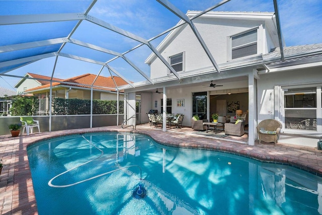 view of swimming pool with glass enclosure, a fenced in pool, outdoor lounge area, and a ceiling fan