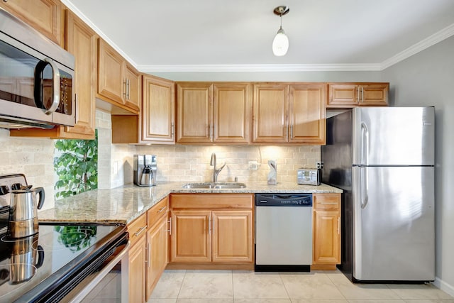 kitchen with light stone counters, a sink, hanging light fixtures, ornamental molding, and appliances with stainless steel finishes