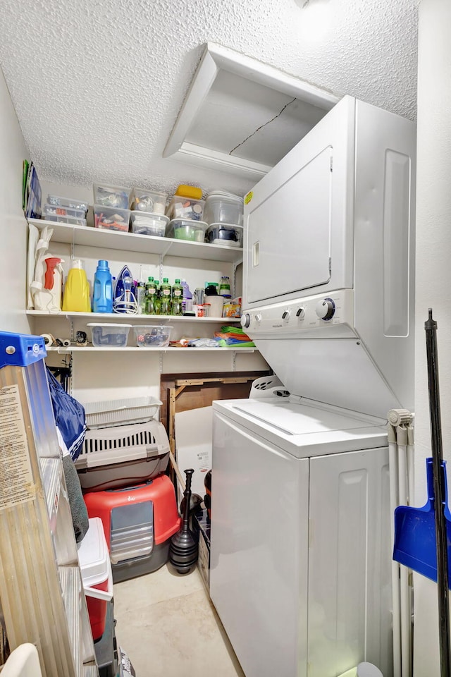 154 Lake Meryl Dr Unit 255, West Palm Beach, FL 33411 - laundry room featuring stacked washing machine and dryer and a textured ceiling