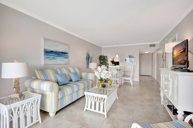 living room featuring light tile patterned floors, visible vents, baseboards, and crown molding