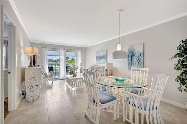 dining room with crown molding, light tile patterned floors, and baseboards
