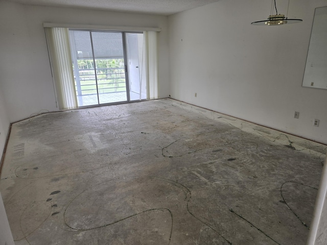 unfurnished room with a textured ceiling