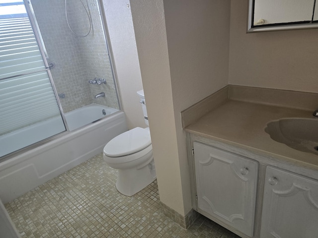 full bath featuring enclosed tub / shower combo, vanity, and toilet