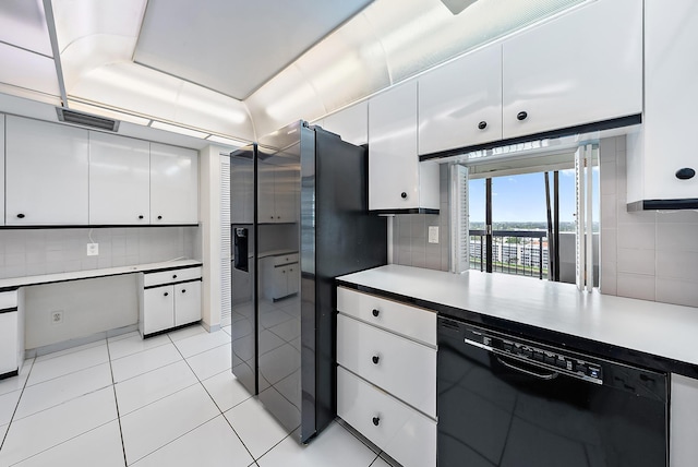 kitchen featuring decorative backsplash, light countertops, black dishwasher, and white cabinetry
