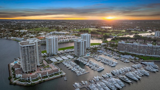 aerial view at dusk with a view of city and a water view