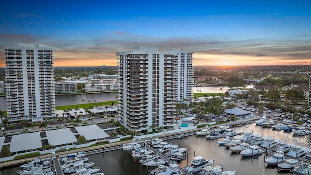 aerial view at dusk with a water view and a view of city