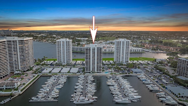 aerial view at dusk with a city view and a water view