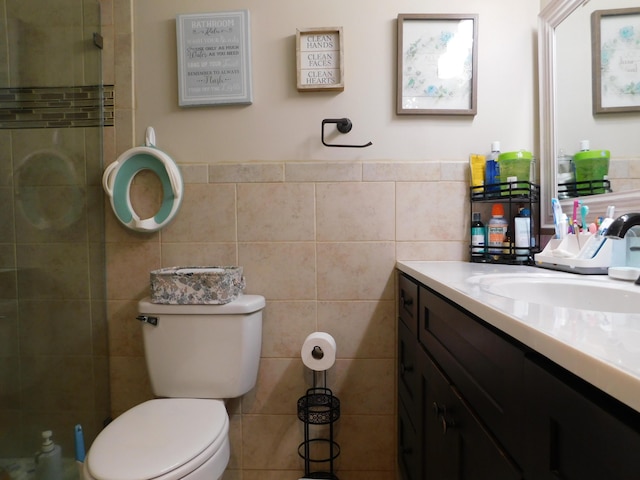 full bath with toilet, tile walls, and vanity