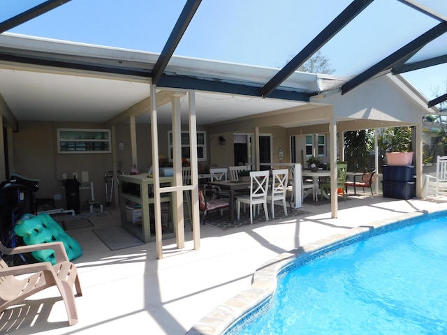 pool with a patio area and glass enclosure