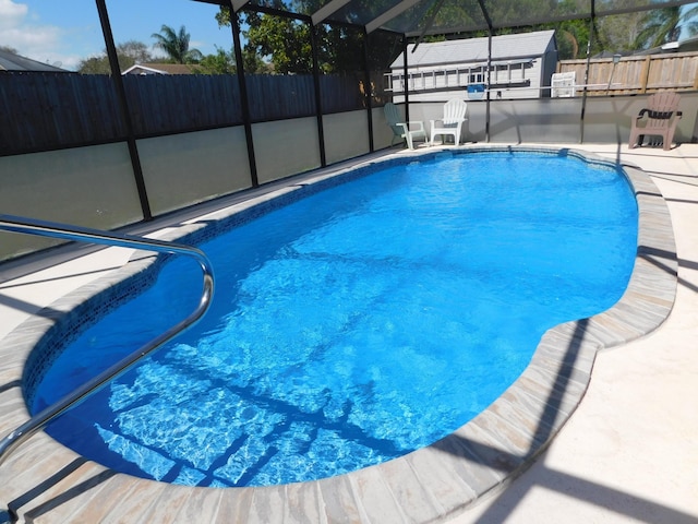 view of pool with a fenced in pool, a lanai, a fenced backyard, and a patio