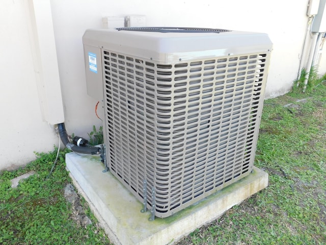 exterior details with stucco siding and central AC unit