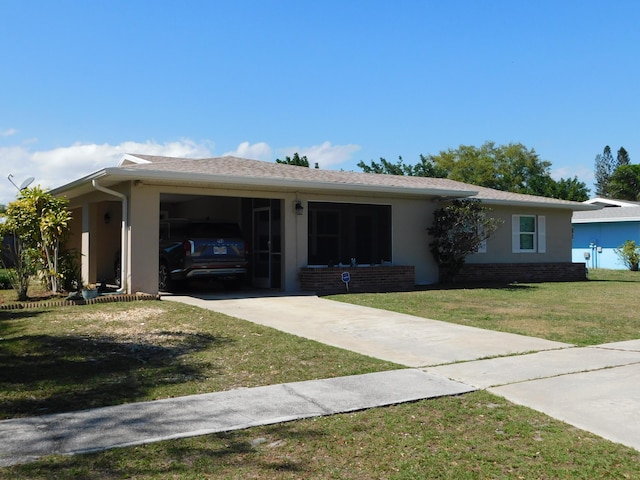 single story home featuring brick siding, a front yard, concrete driveway, and stucco siding