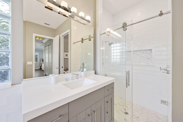 bathroom featuring a shower stall, visible vents, and vanity