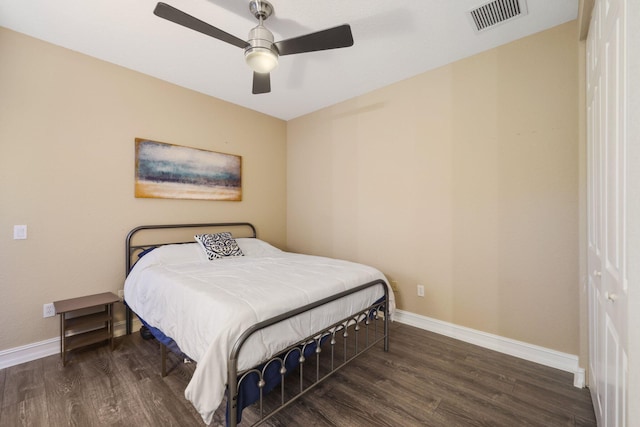 bedroom featuring dark wood-type flooring, visible vents, and baseboards