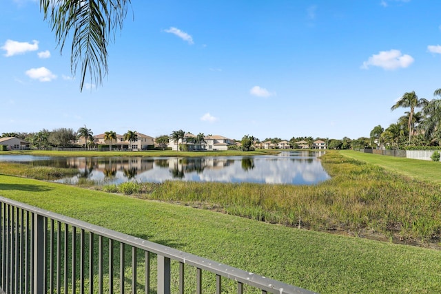 view of water feature with a residential view and fence