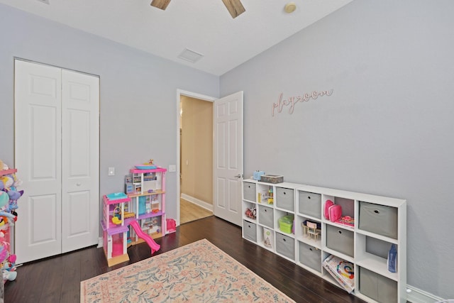 playroom with ceiling fan, baseboards, and dark wood-style flooring