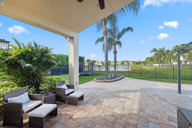 view of patio featuring a fenced backyard and a water view