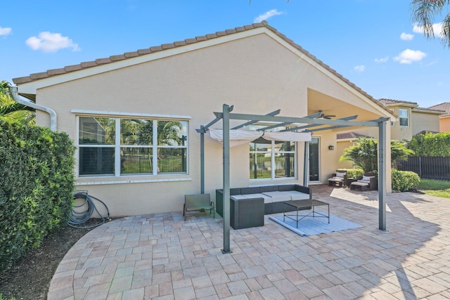 back of house featuring fence, an outdoor hangout area, a patio, and stucco siding