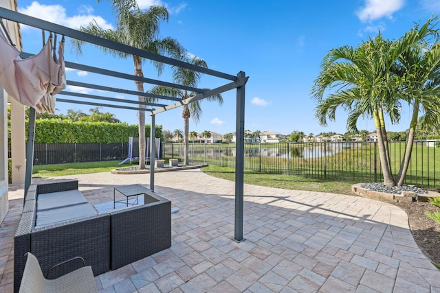 view of patio / terrace featuring a water view, a fenced backyard, an outdoor living space, and a pergola