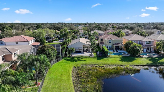 drone / aerial view featuring a residential view and a water view