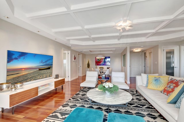 living room with beam ceiling, coffered ceiling, baseboards, and wood finished floors