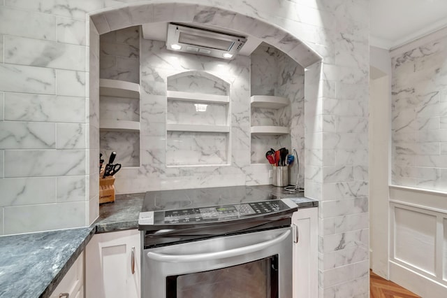 kitchen featuring white cabinets, stainless steel electric range, decorative backsplash, dark stone counters, and open shelves